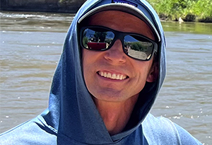 man with water scene behind him