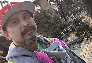 man with red baseball cap outside