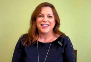 women wearing black top smiling