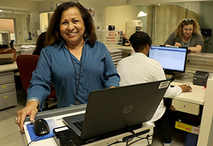 woman smiling working on a computer 