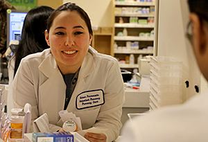 woman smiling in white lab coat