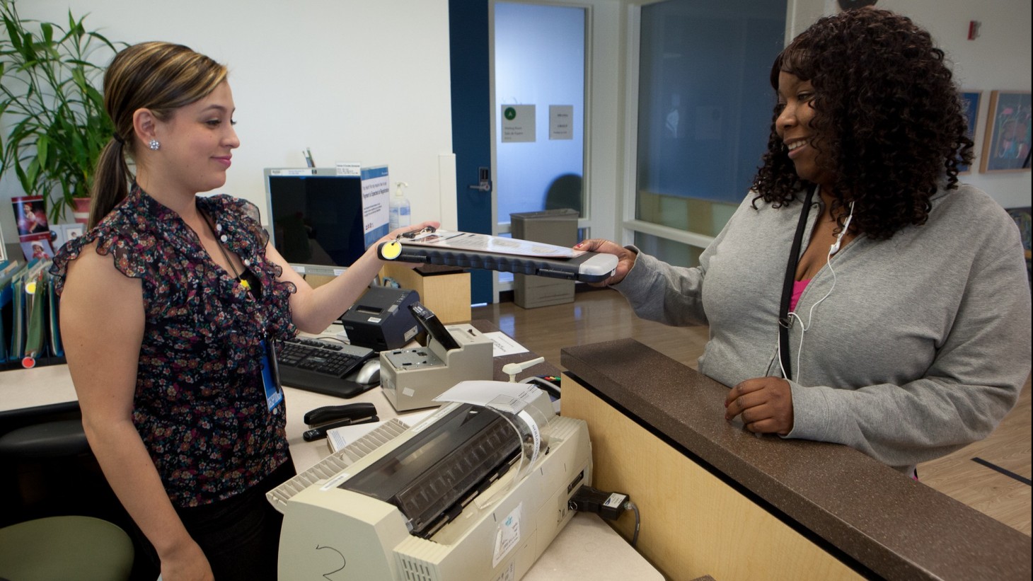 Receptionist greeting a patient at a clinic 