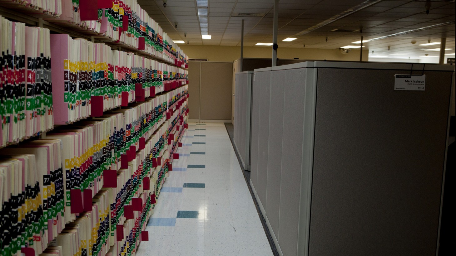 A long shelf of medical record folders 