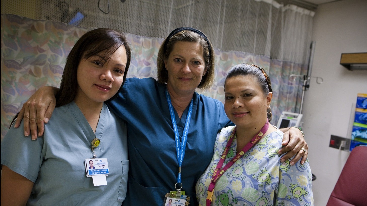 three nurses wearing blue scrubs