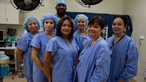 A diverse group of health care workers wearing blue scrubs